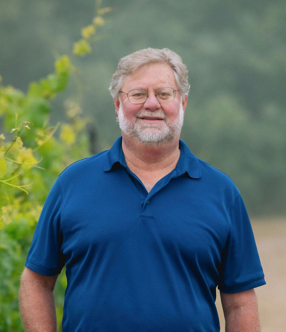 Jeff Stewart standing in a vineyard